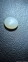 Top view of oval pearl-white moonstone cabochon