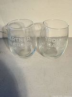Both etched stemless glasses side by side