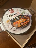 Top view of unopened Carmencita paella pan with Paella kit sleeve