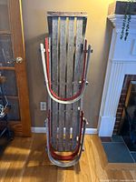 Full view of upright wooden sled showing overall design and size