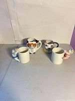 Four assorted 3D figural ceramic mugs front view