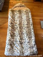 Full view of faux fur sleeping bag laid flat