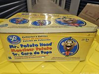 Side view of Mr. Potato Head yellow tin