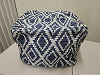 Front view of blue and white diamond pattern pouf