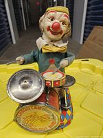 Front view of Charlie the Drumming Clown with drums visible