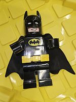 Front view of large LEGO Batman alarm clock showing LCD display, belt, cape, 8-inch scale