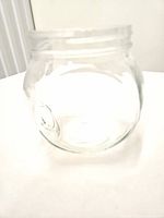 angled view of clear glass jar without lid