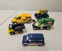 Five of the nine die-cast vehicles on tabletop