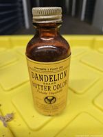 Amber glass bottle with Dandelion Butter Color label