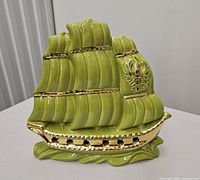 Front view of green ceramic ship lamp with gold accents