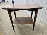 Front view of two-tier side table showing overall design and condition