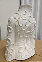 Rear view displaying back scroll pattern and glaze finish