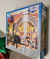Front view of Justice League puzzle box showing artwork and 1000-piece count