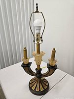 Full view of lamp showing three arms, harp, bulb socket and overall style
