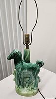 Front view of green glazed ceramic horse lamp showing horse figure and socket