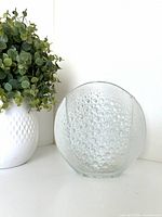 Front view of circular bubble-textured glass vase