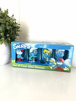 Front view of boxed set of four Smurfs 16oz glasses
