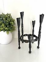 Full view of cast iron candelabra showing four tall arms and central area
