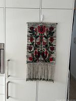 Front view of entire tapestry hanging on cabinet
