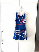 Front view of blue Philadelphia 76ers jersey dress on hanger