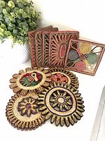 Group of nine woven raffia trivets in various shapes and colours