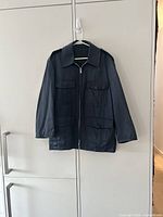 Full front view of navy Toronto Police chore jacket hanging