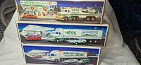 Front view of all three Hess toy truck boxes stacked