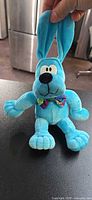 Front view of blue Commonwealth Hot Hound plush dog showing bowtie and facial details