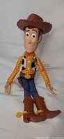 Full view of Woody talking figure lying flat
