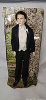 Full view of Groom Edward doll on cardboard backing
