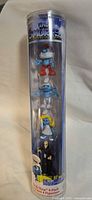 Front view of sealed tube showing all four Smurfs figures