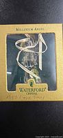 Front view of boxed Waterford Crystal Millennium Angel showing window and branding