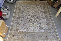 Full view of the large area rug laid flat on the floor showing the entire design and border.