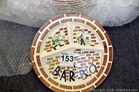 Showing one ceramic BBQ plate with three divided sections, brick wall design and barbecue illustrations.