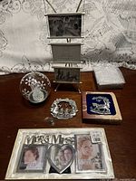 Full lot overview showing frames, glass ball ornament, pewter ornaments