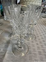 Group of taller crystal stemmed glasses on table