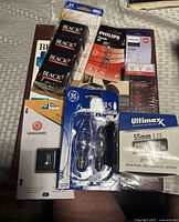 Stacked view of all items: album, film, bulbs, quick shoe, lens