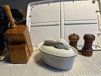 Group view of pepper grinder, salt shaker, knife block, sharpener, rabbit dish