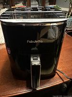 Front view of black Fabulletta air fryer with push-button basket handle