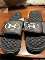 Top view of slides showing logos, straps, footbeds, condition
