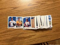 Stack of roughly 100 1991 Upper Deck baseball cards with three individual cards shown for reference