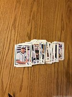 Stacked spread of baseball cards on wood surface