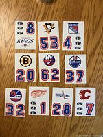 Fronts of ten Topps 1985-86 helmet decal stickers showing team logos and numbers