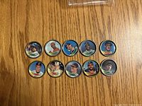 Fronts of ten 1989 Topps baseball coins displayed on wood surface