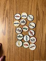 Obverse view showing illustrations and numbering on all 15 Salada car coins