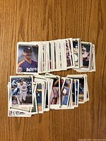 Stacks of 1990 Upper Deck baseball cards displayed on a wooden surface