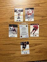 Front of five player stickers and sealed pack on wood surface