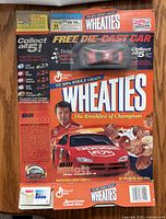 Front of Wheaties box showing Bill Elliott graphics and sealed die-cast car
