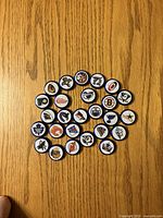 All 26 Labatt beer caps arranged on wood surface showing various NHL logos