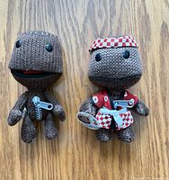 Front view of both Sackboy plush toys showing details and size